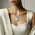 woman/lady wearing ivory gemstone necklace