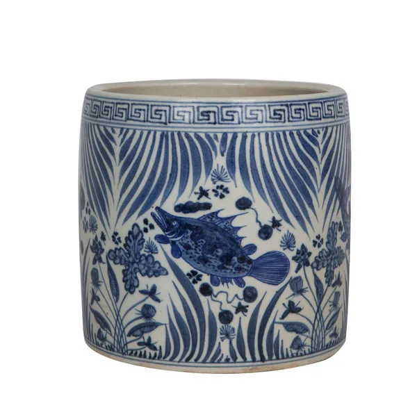 Close view of blue fish motifs and patterned borders on a porcelain cachepot