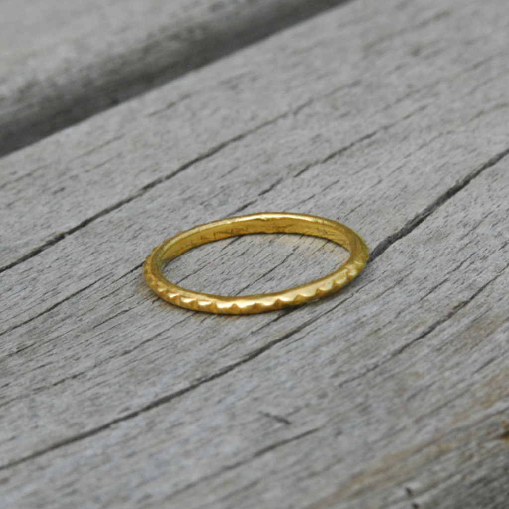 delicate simple 14 carat gold plated sterling silver stacking ring with a bit of edge