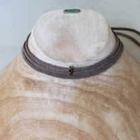 grey leather wrap necklace with brass and smoky quartz detail