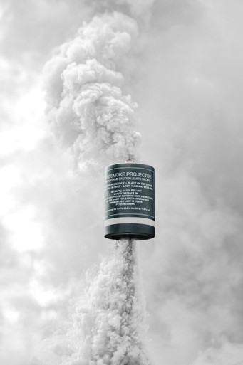 White smoke grenade with a tall, dense white smoke column rising straight up against a soft pale backdrop