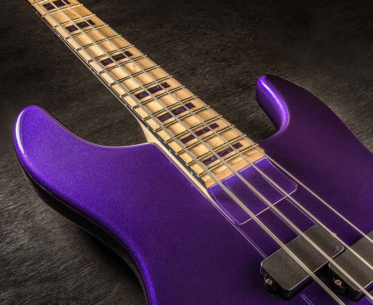 Bass strings running across the pickups and pickguard and over the neck.