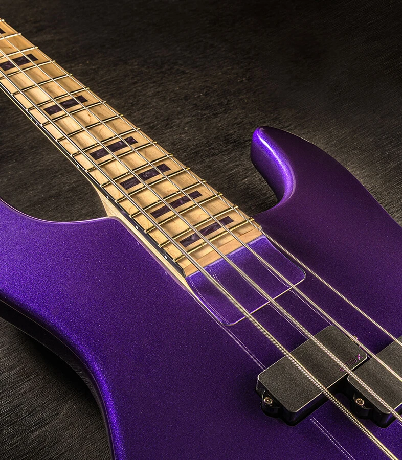 Bass strings running across the pickups and pickguard and over the neck.