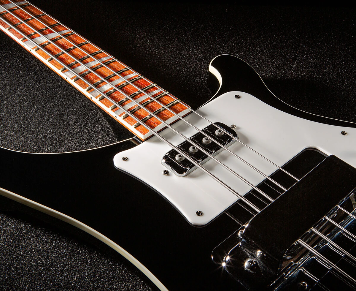 Bass strings running across the pickups and pickguard and over the neck.