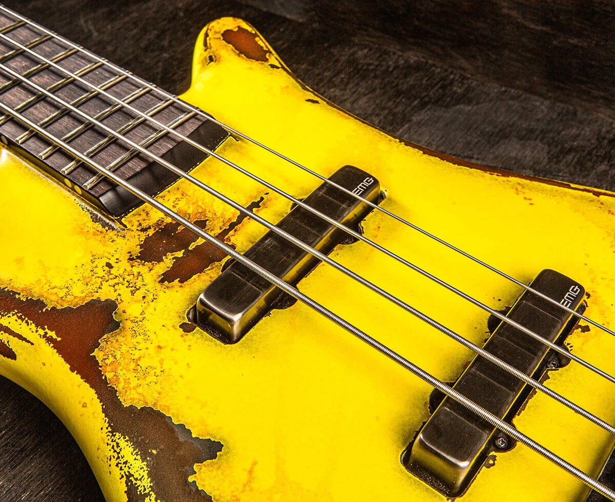 Bass strings running across the pickups and pickguard and over the neck.