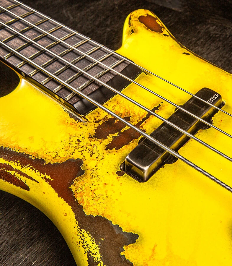 Bass strings running across the pickups and pickguard and over the neck.