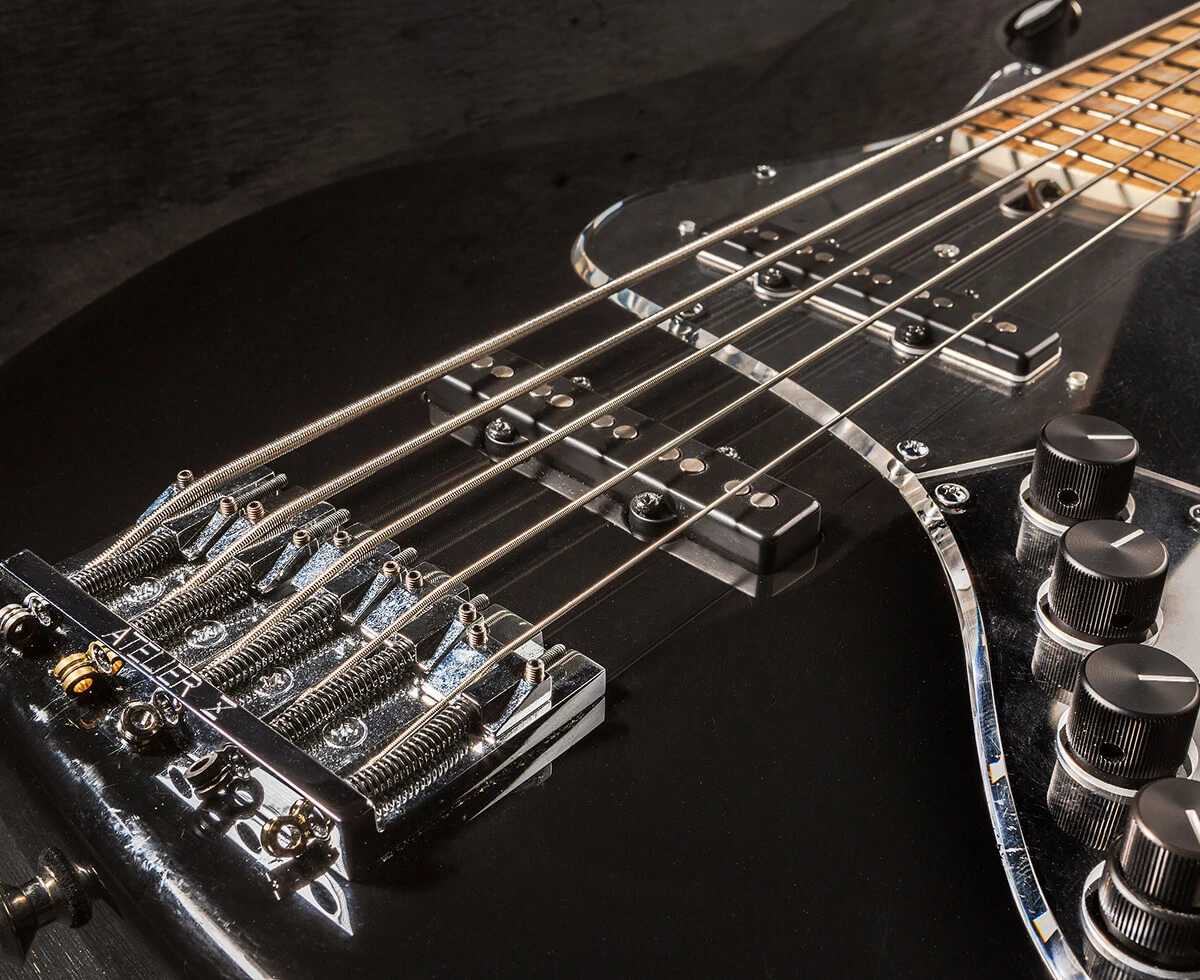Bass strings running across the pickups and pickguard toward the neck.