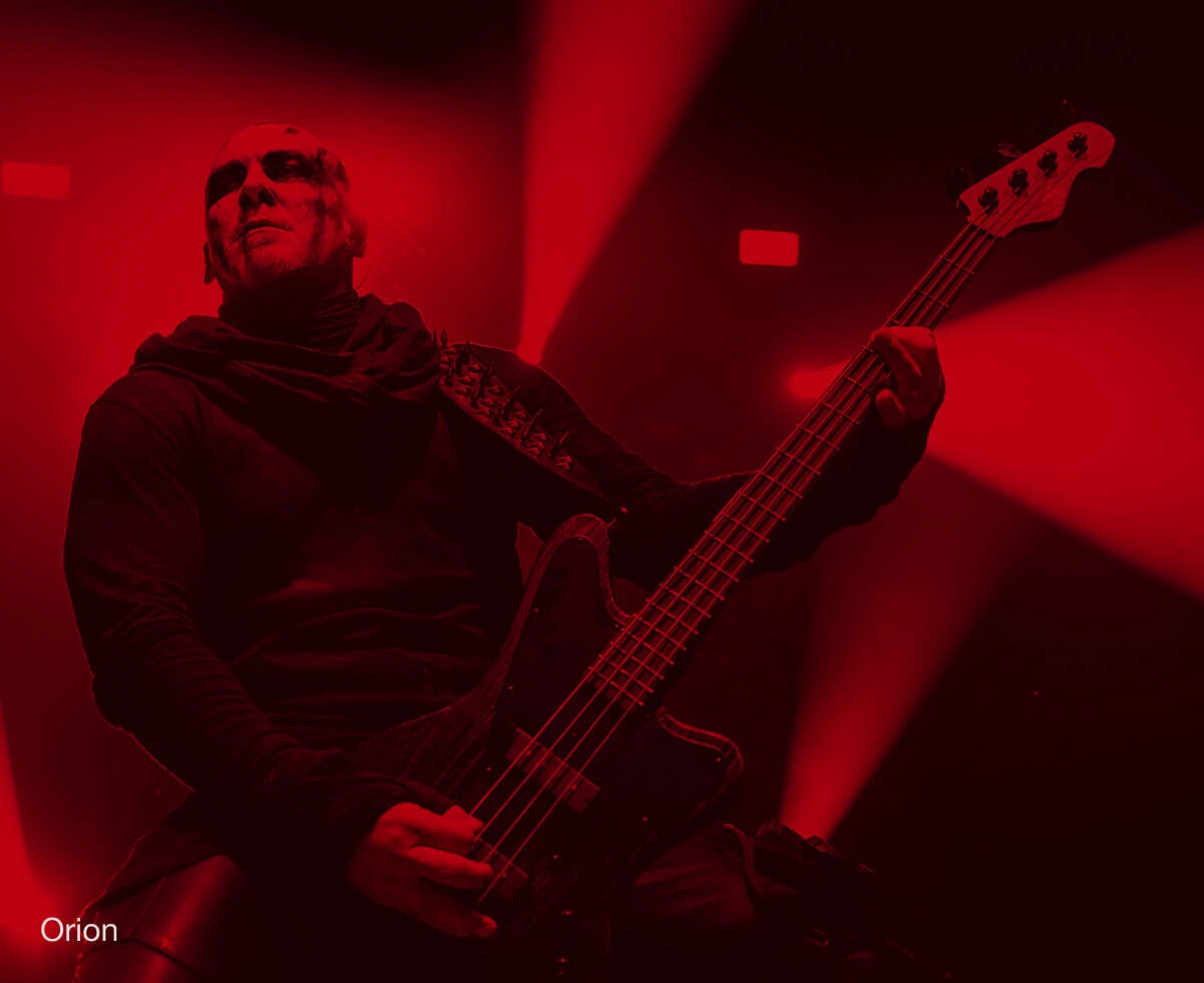 Bassist Orion performing live with a bass.