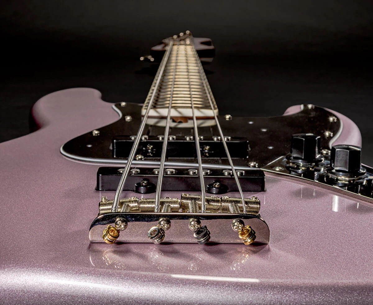 The strings of a four-string bass anchored at the bridge saddles.