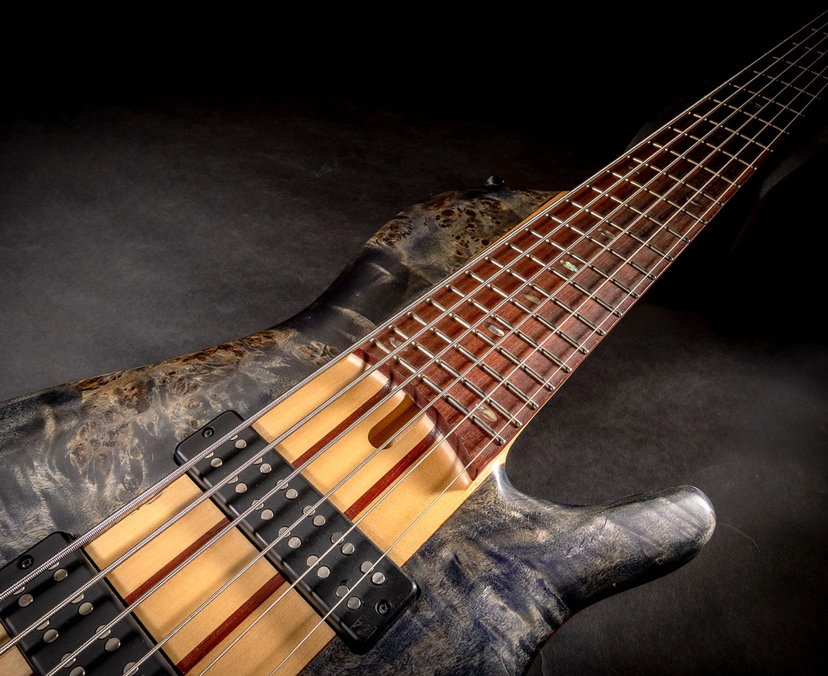 A six-string bass on a black background.