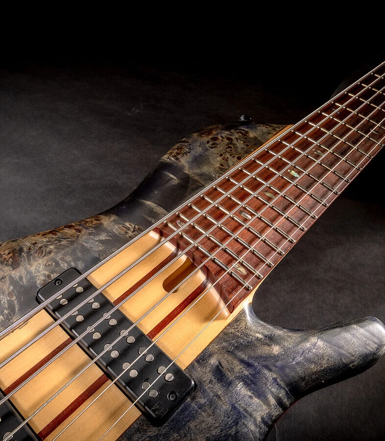 A six-string bass on a black background.