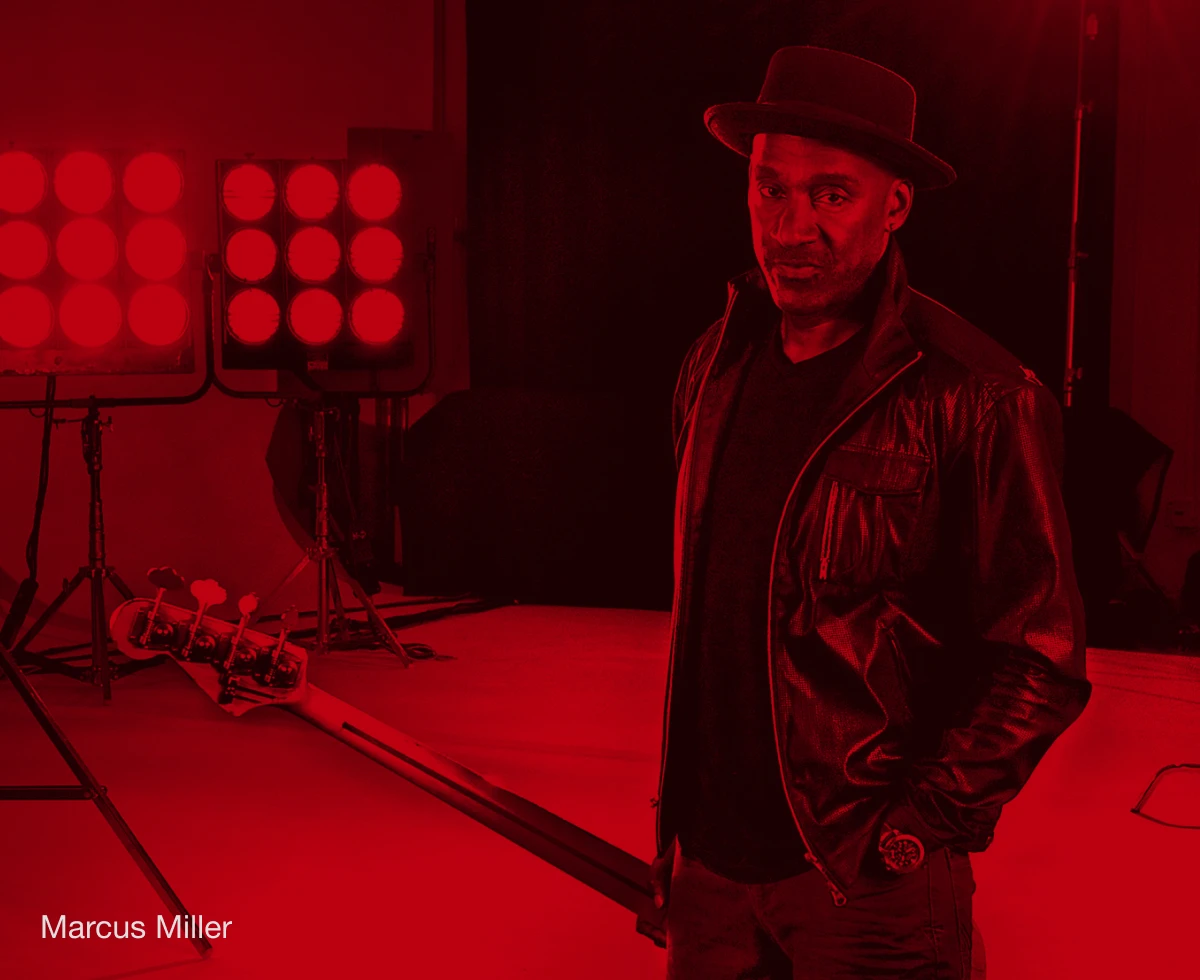 Bassist Marcus Miller holding a bass.