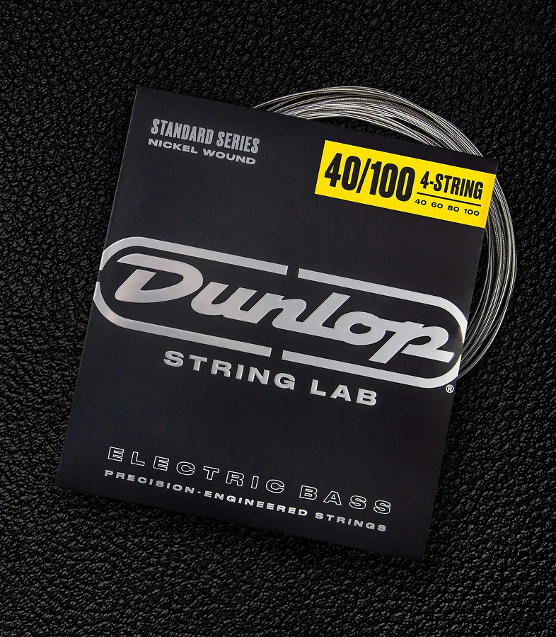 A Dunlop bass string package with the coiled strings fanned out beside it.