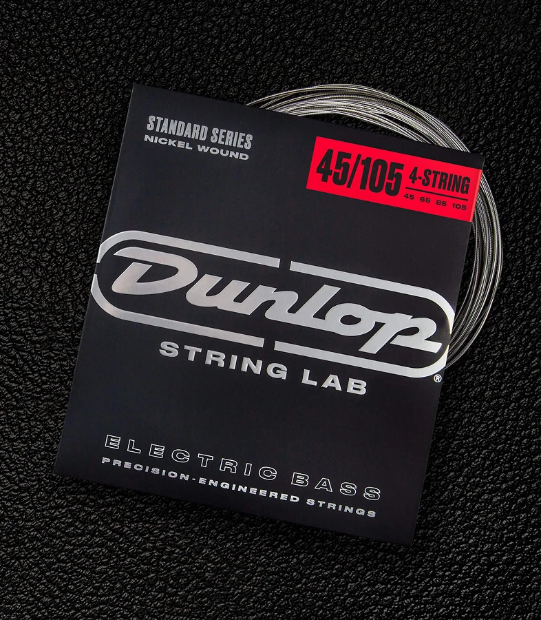 A Dunlop bass string package with the coiled strings fanned out beside it.