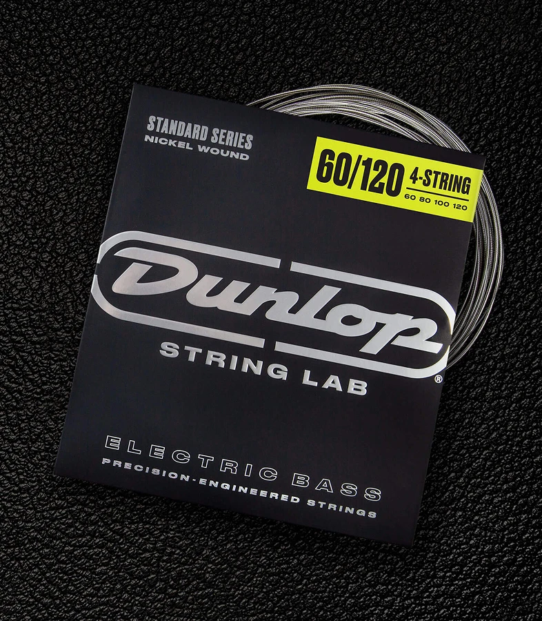 A Dunlop bass string package with the coiled strings fanned out beside it.