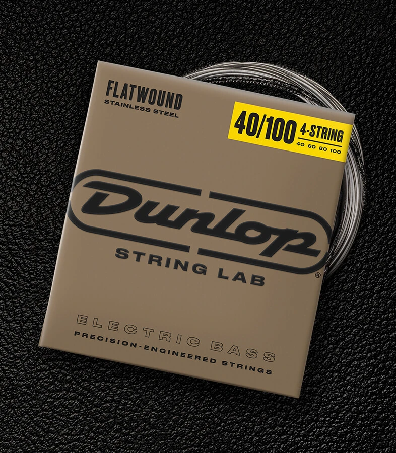 A Dunlop bass string package with the coiled strings fanned out beside it.