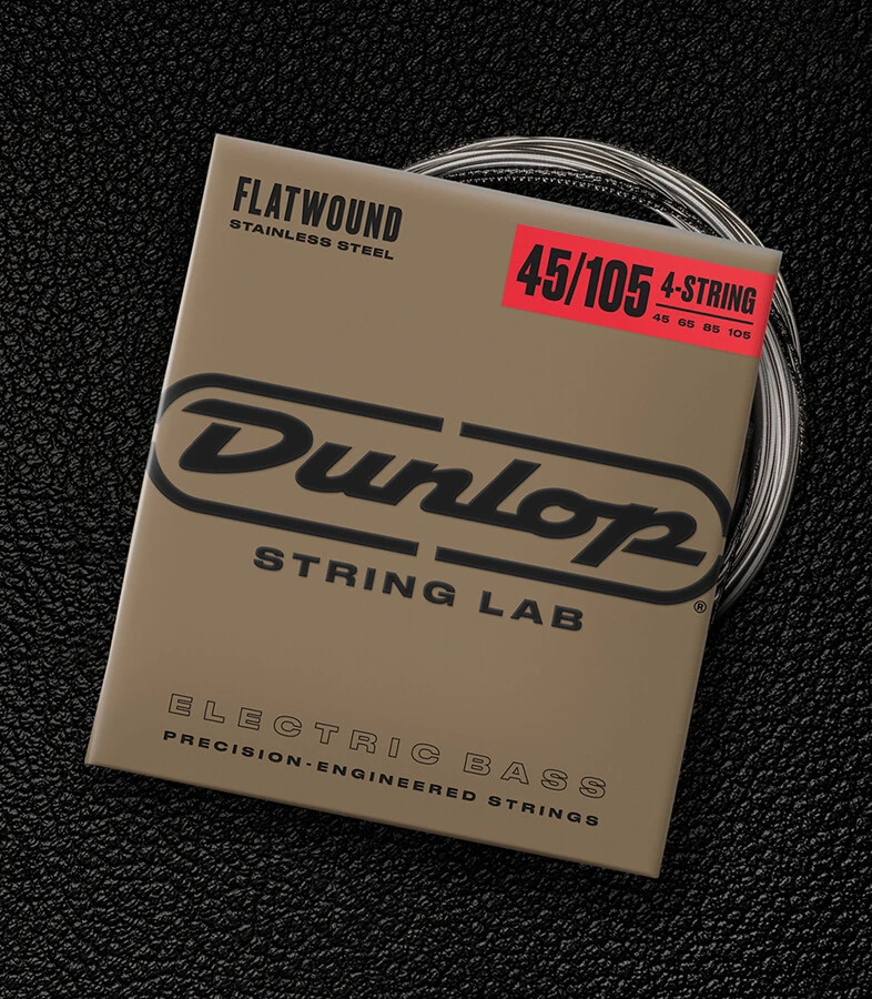A Dunlop bass string package with the coiled strings fanned out beside it.