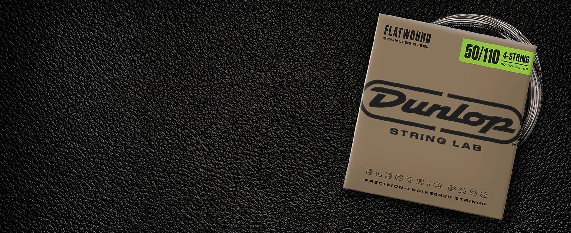 A Dunlop bass string package with the coiled strings fanned out beside it.