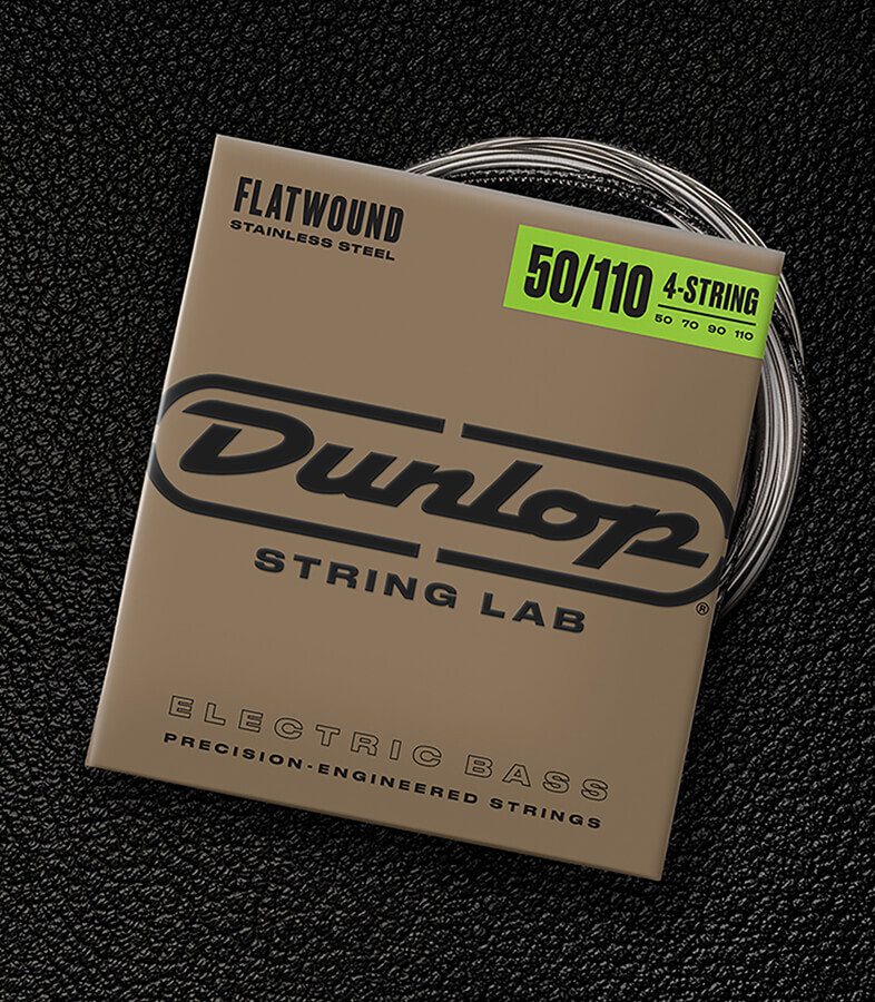 A Dunlop bass string package with the coiled strings fanned out beside it.
