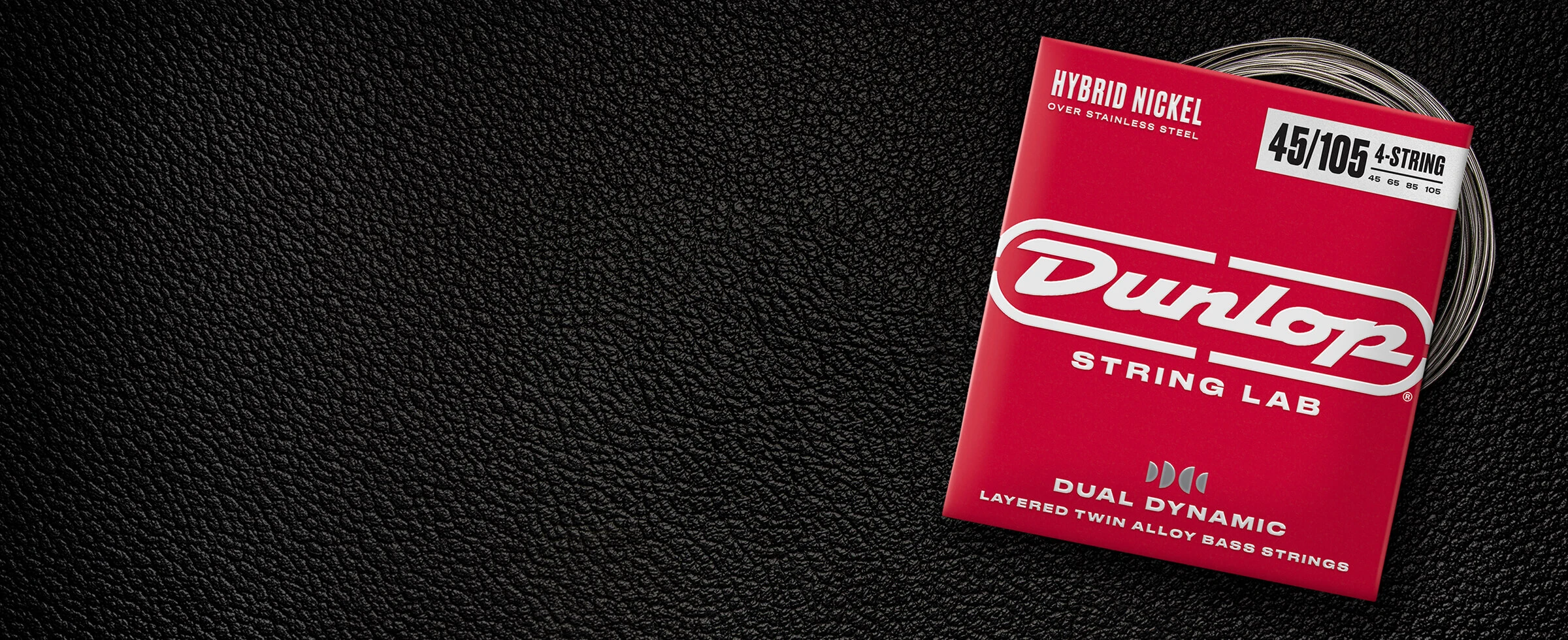 A Dunlop bass string package with the coiled strings fanned out beside it.