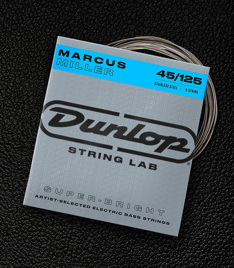 A Dunlop bass string package with the coiled strings fanned out beside it.