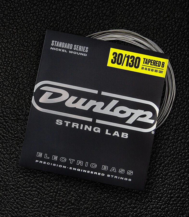 A Dunlop bass string package with the coiled strings fanned out beside it.