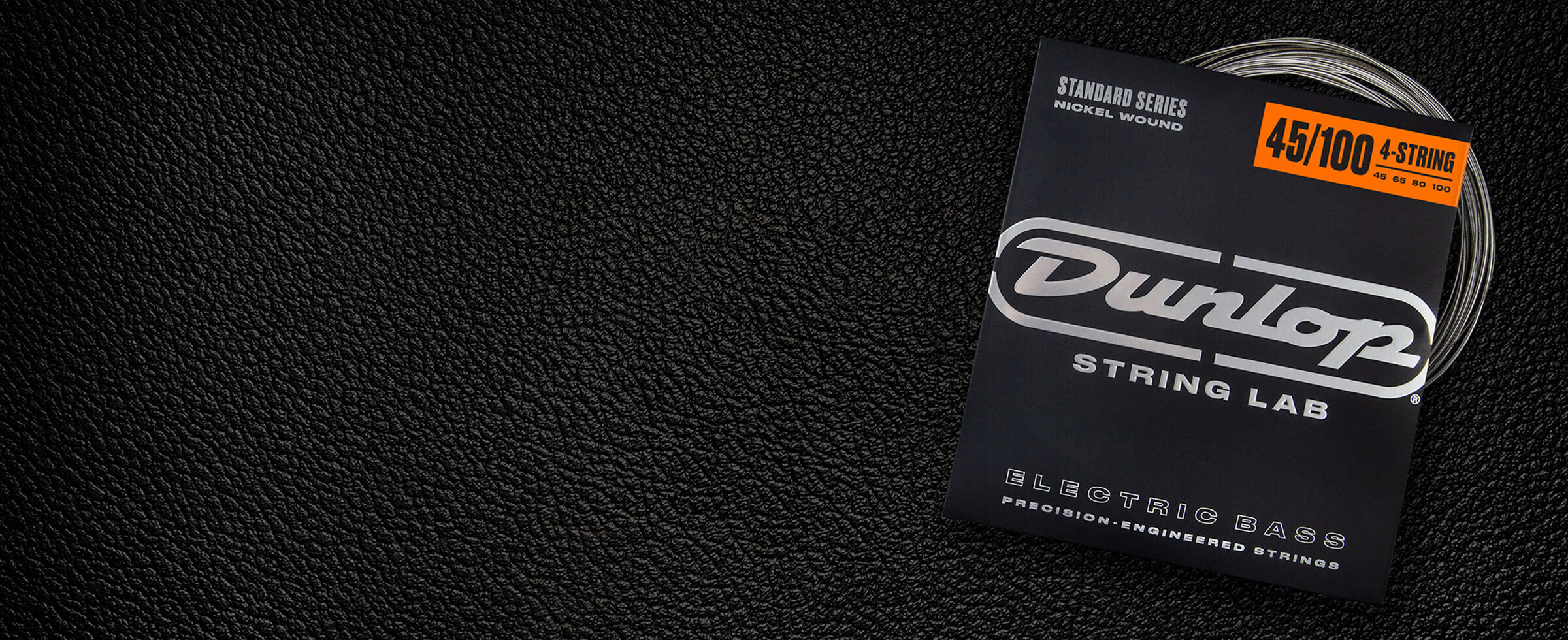 A Dunlop bass string package with the coiled strings fanned out beside it.