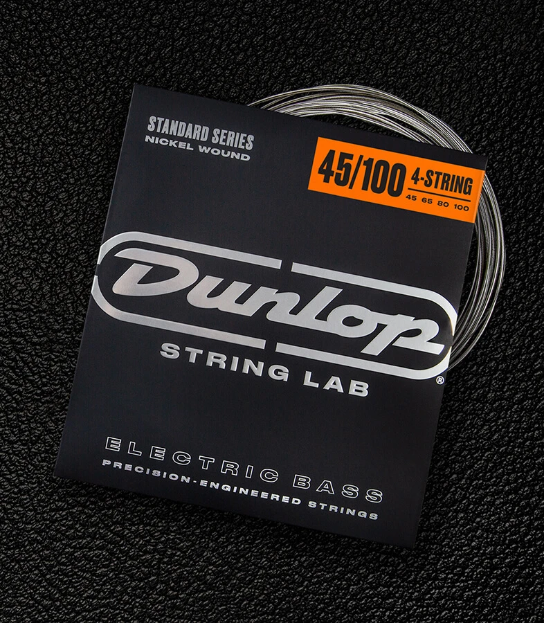 A Dunlop bass string package with the coiled strings fanned out beside it.