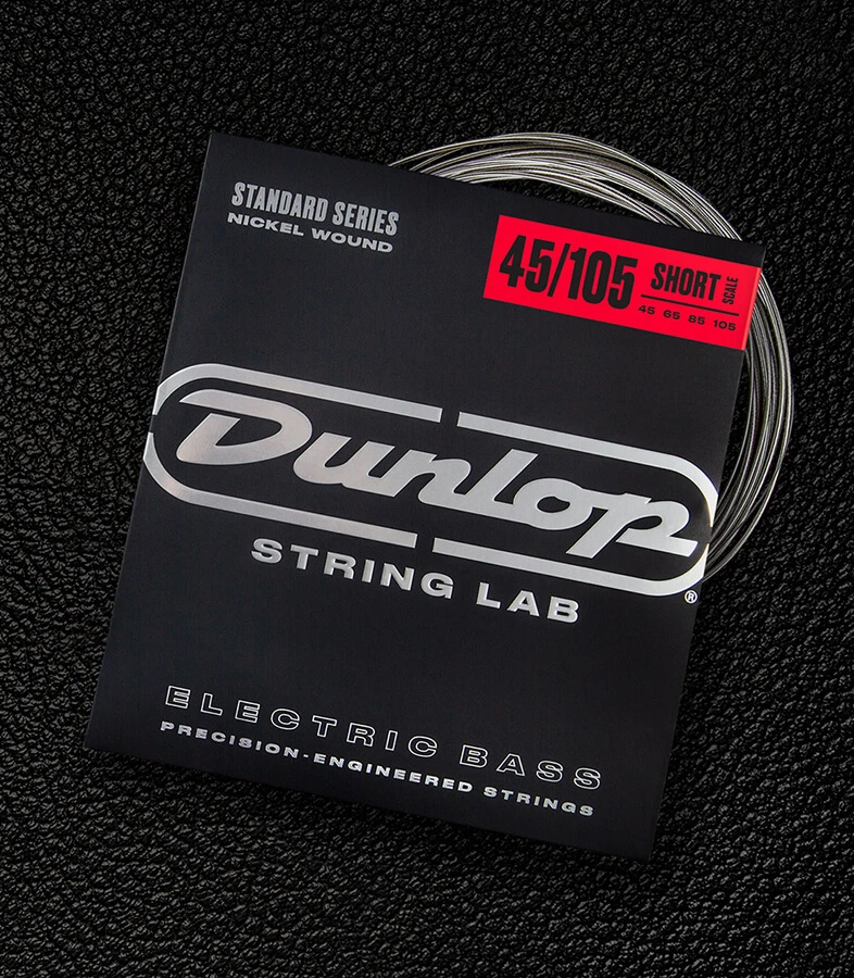 A Dunlop bass string package with the coiled strings fanned out beside it.