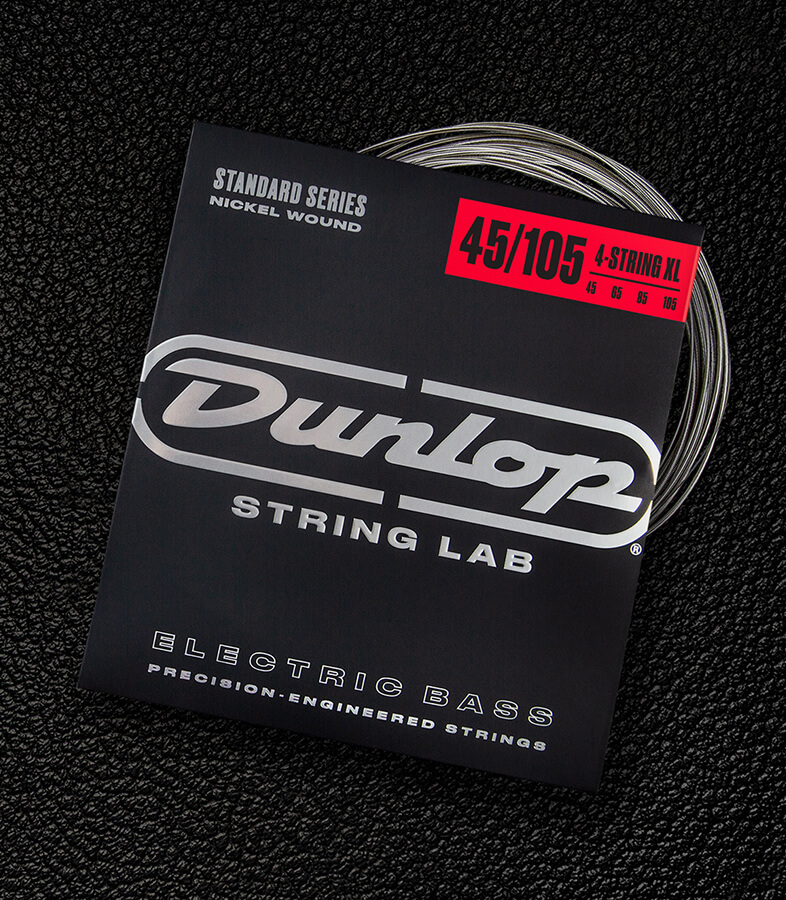 A Dunlop bass string package with the coiled strings fanned out beside it.