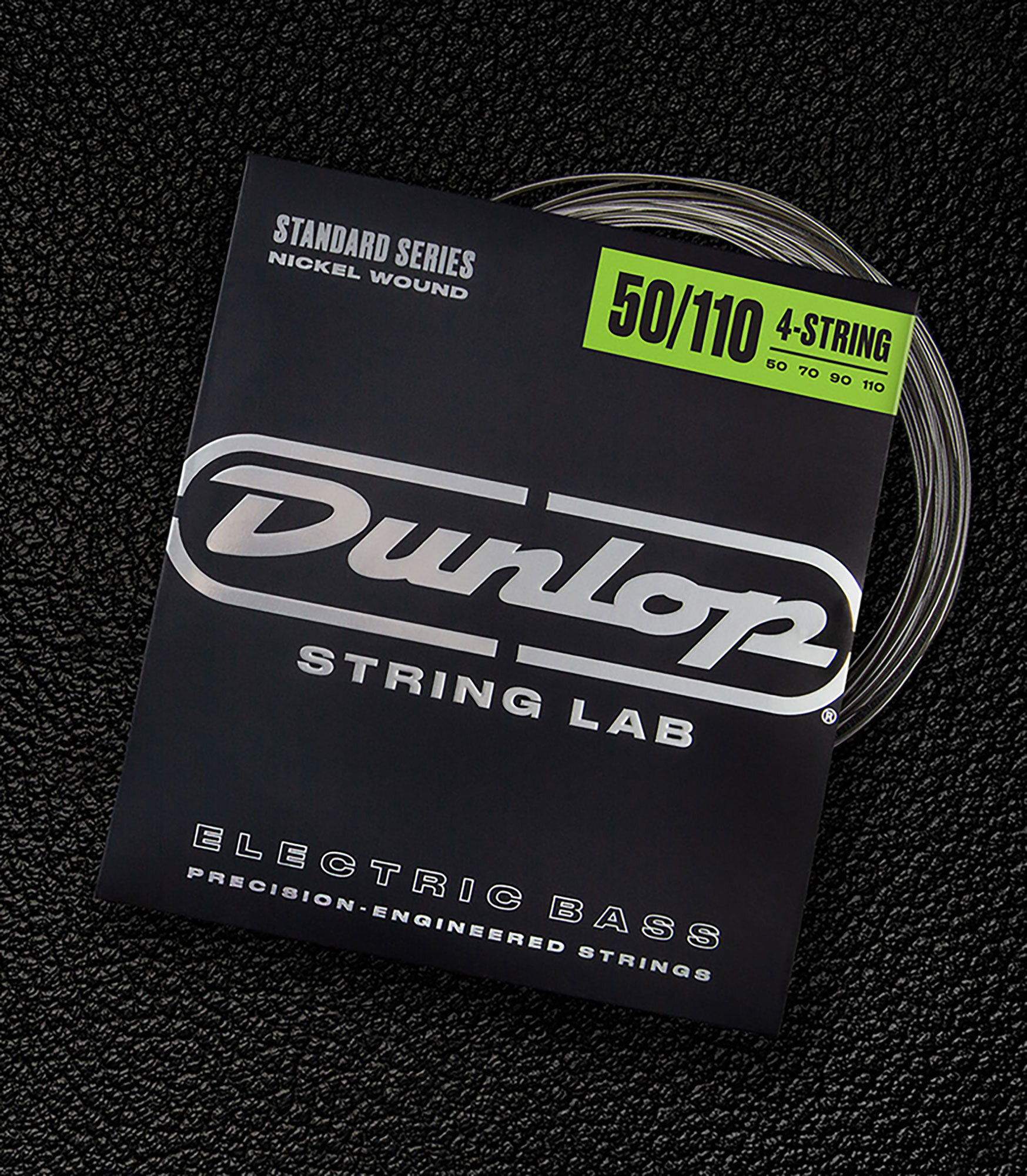 A Dunlop bass string package with the coiled strings fanned out beside it.