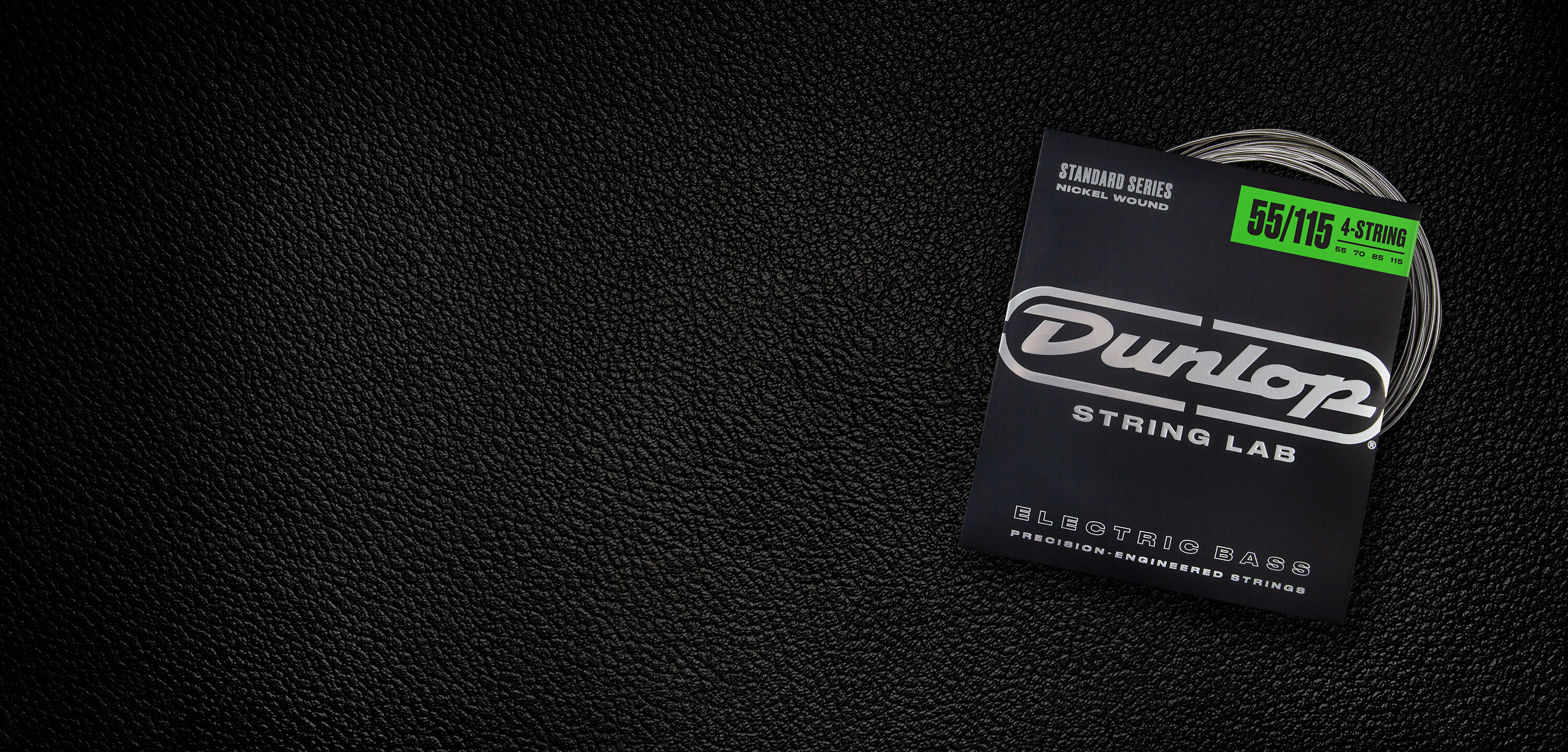 A Dunlop bass string package with the coiled strings fanned out beside it.
