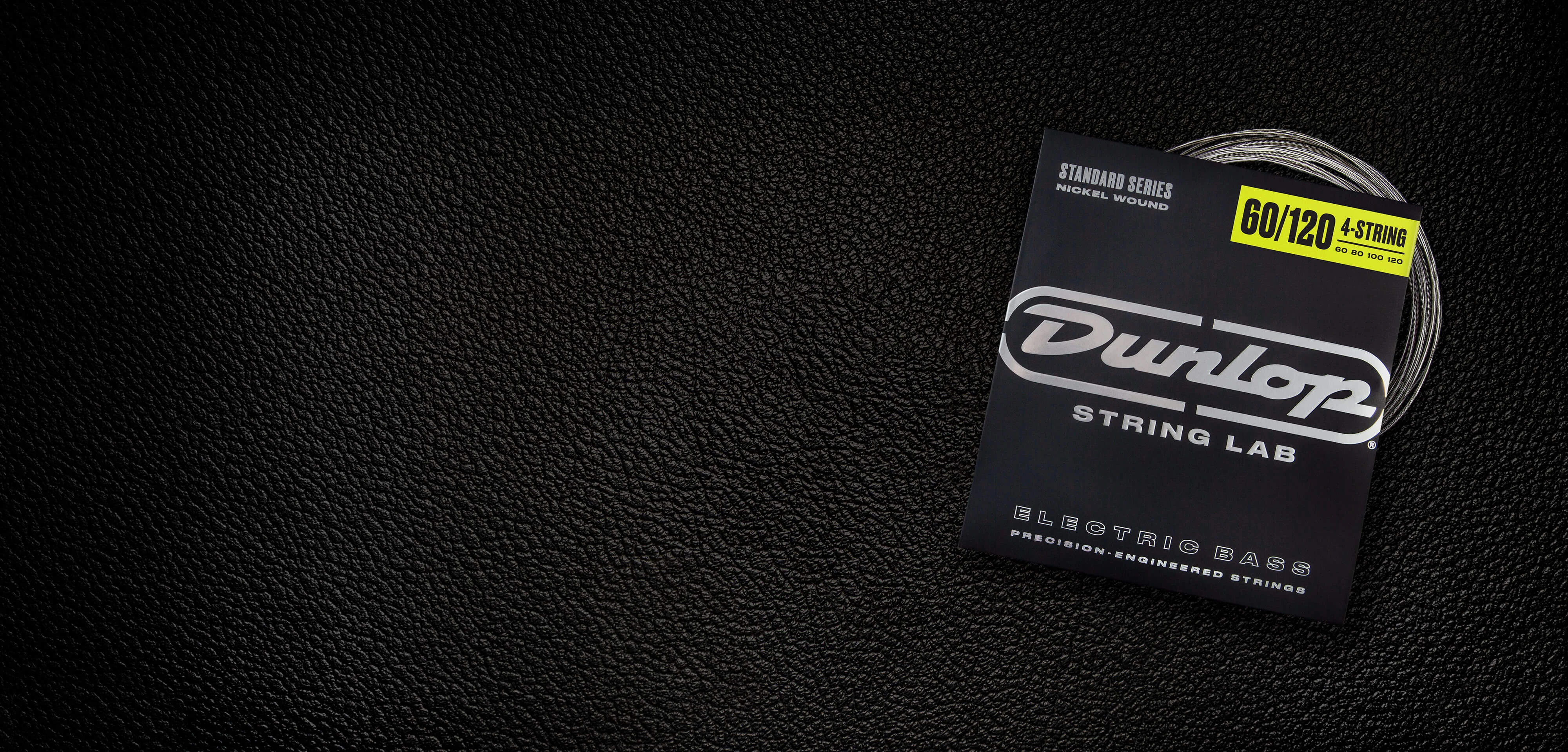 A Dunlop bass string package with the coiled strings fanned out beside it.