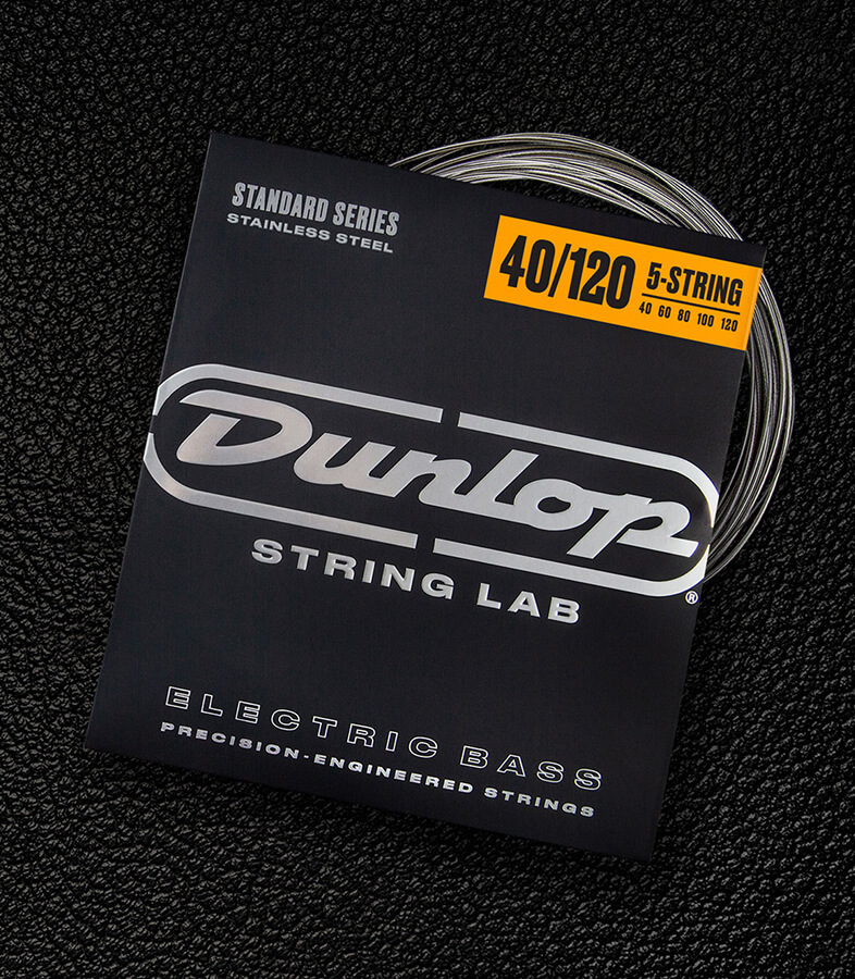 A Dunlop bass string package with the coiled strings fanned out beside it.