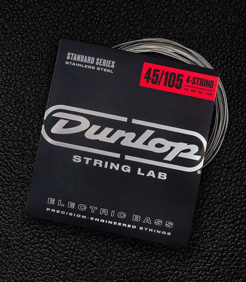 A Dunlop bass string package with the coiled strings fanned out beside it.