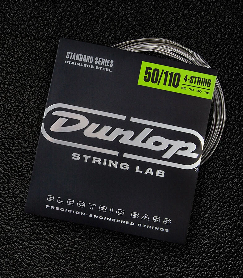A Dunlop bass string package with the coiled strings fanned out beside it.
