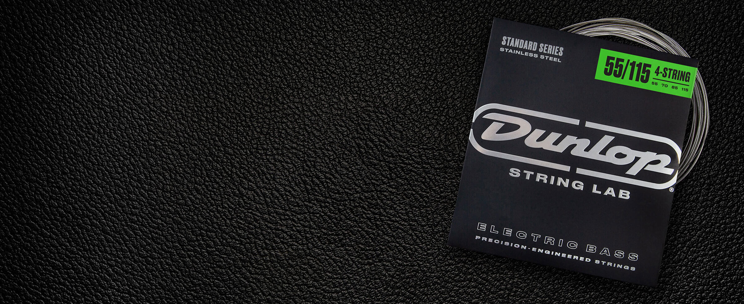 A Dunlop bass string package with the coiled strings fanned out beside it.