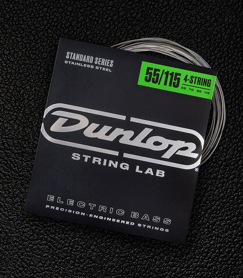 A Dunlop bass string package with the coiled strings fanned out beside it.