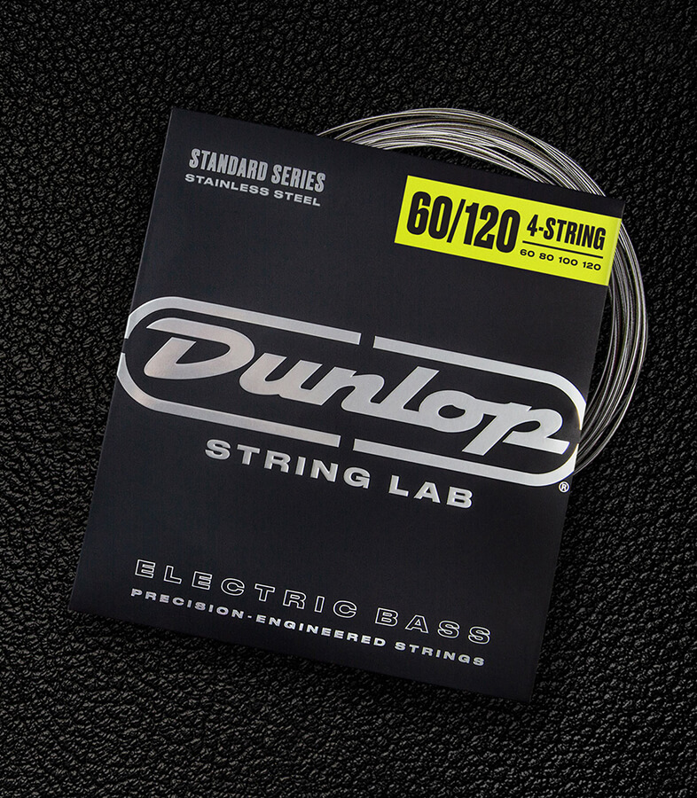 A Dunlop bass string package with the coiled strings fanned out beside it.