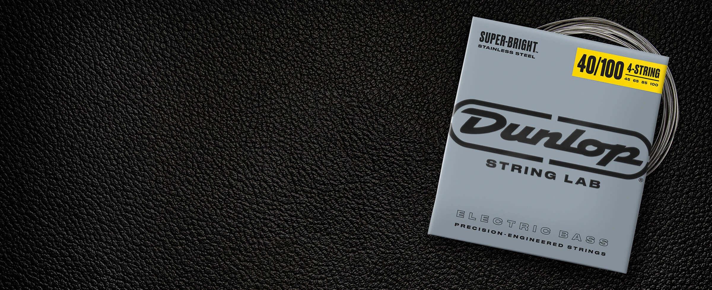 A Dunlop bass string package with the coiled strings fanned out beside it.