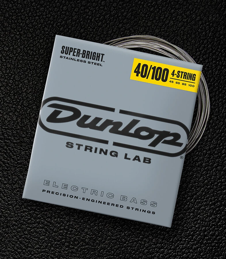 A Dunlop bass string package with the coiled strings fanned out beside it.