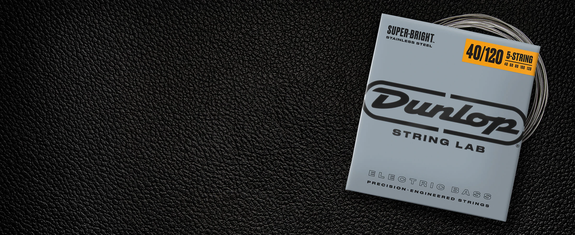 A Dunlop bass string package with the coiled strings fanned out beside it.