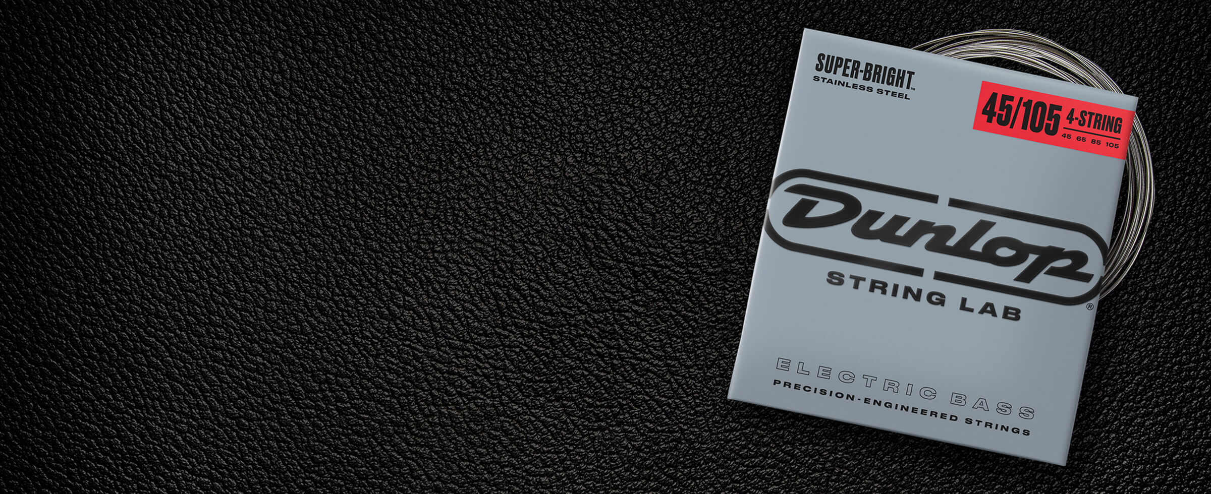 A Dunlop bass string package with the coiled strings fanned out beside it.
