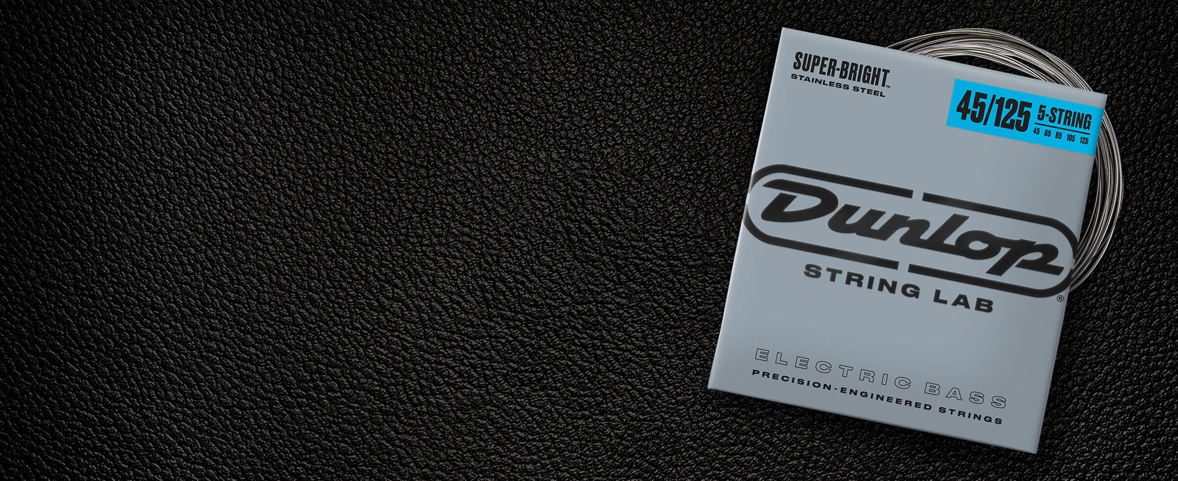 A Dunlop bass string package with the coiled strings fanned out beside it.