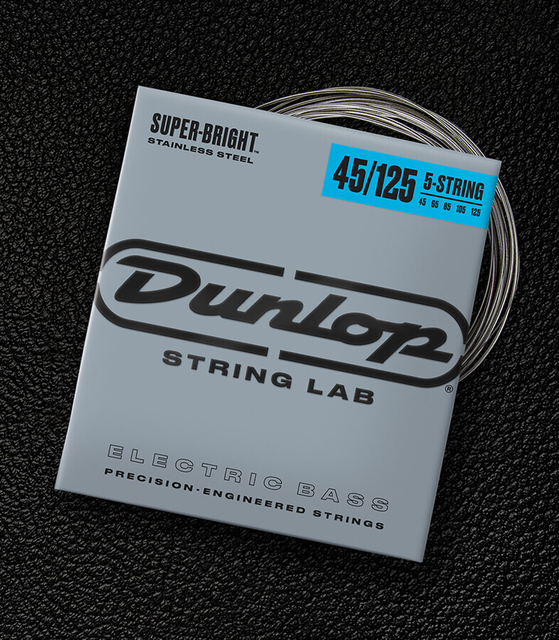 A Dunlop bass string package with the coiled strings fanned out beside it.