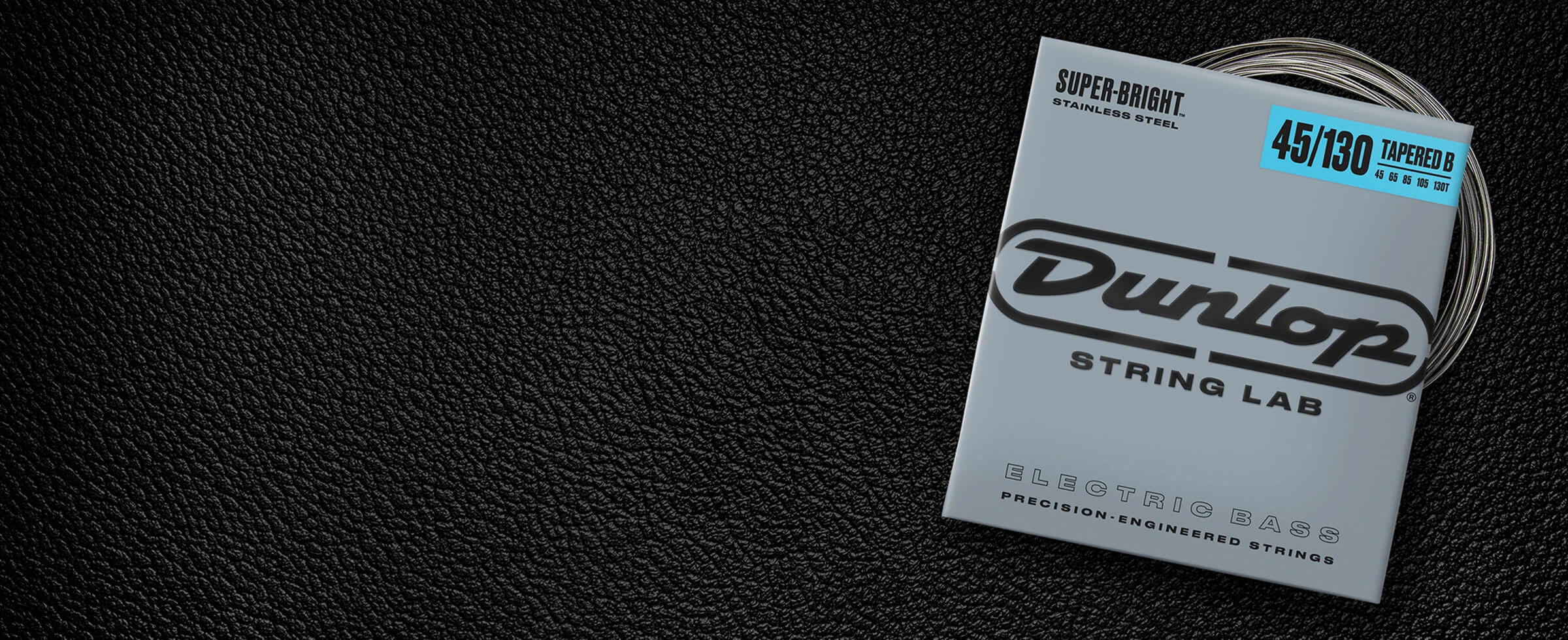 A Dunlop bass string package with the coiled strings fanned out beside it.