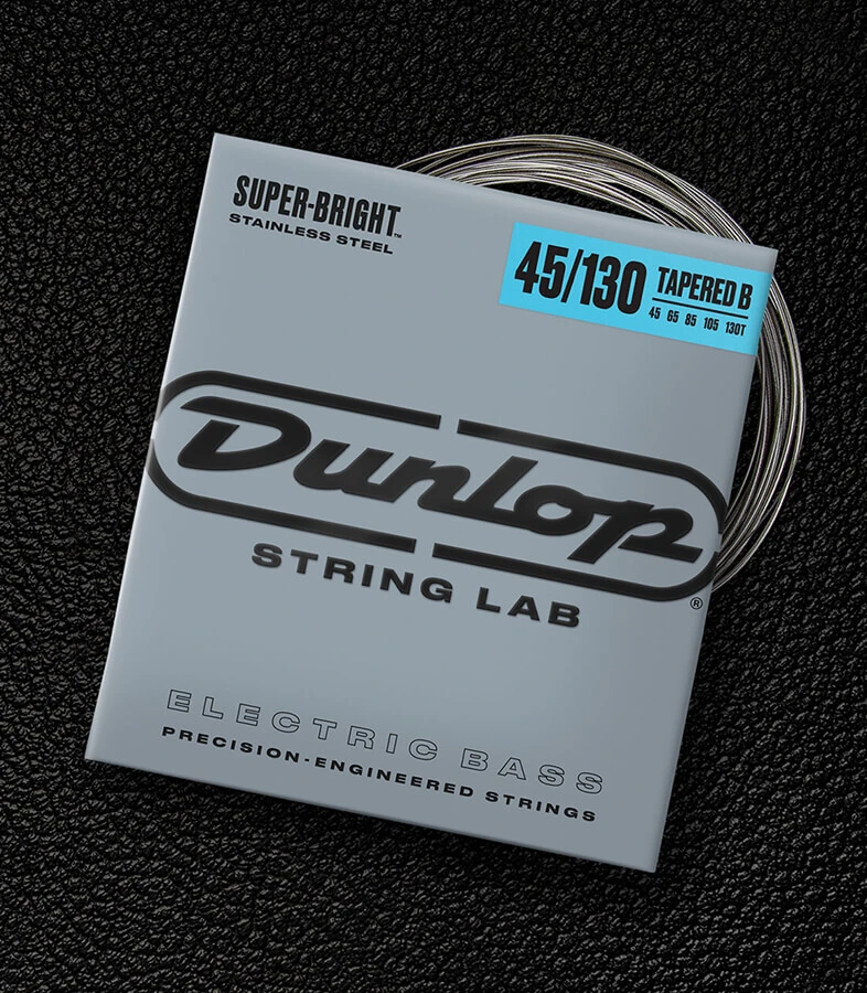 A Dunlop bass string package with the coiled strings fanned out beside it.