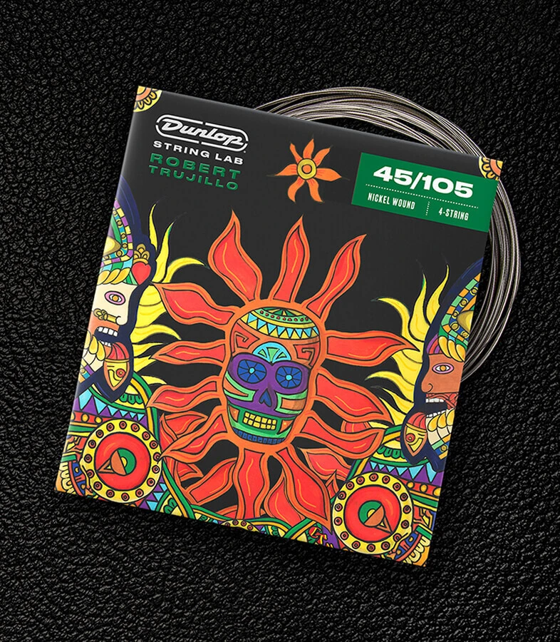 A Dunlop bass string package with the coiled strings fanned out beside it.