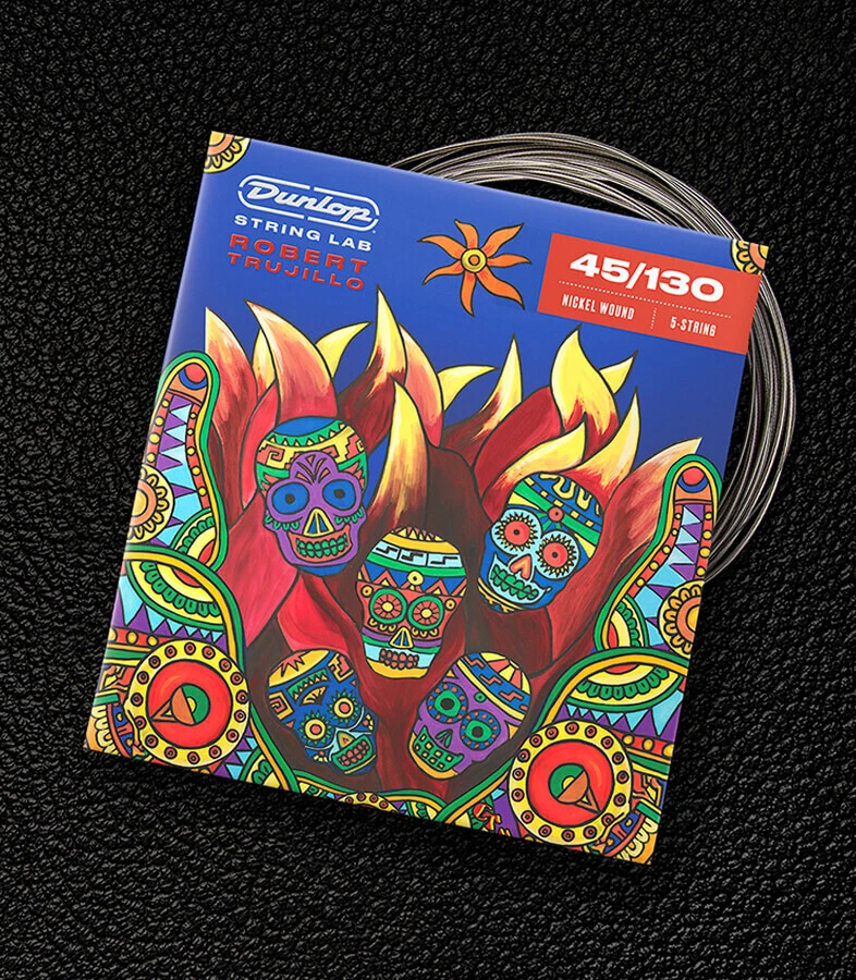 A Dunlop bass string package with the coiled strings fanned out beside it.