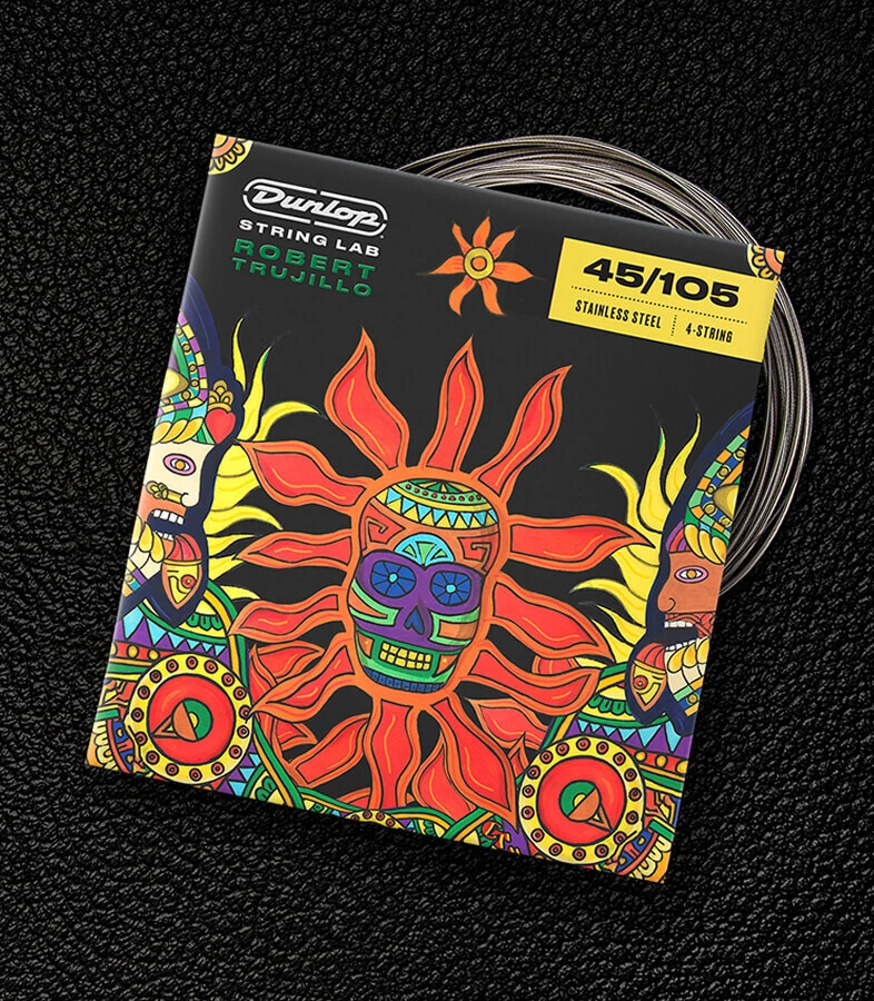 A Dunlop bass string package with the coiled strings fanned out beside it.